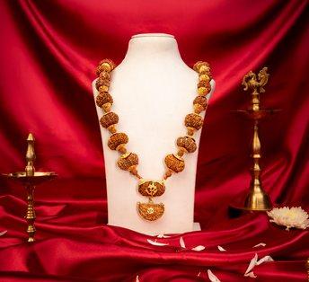 Siddha Mala displayed on a red silk bust