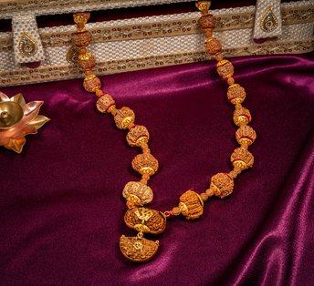 Siddha Mala with gold caps on purple silk